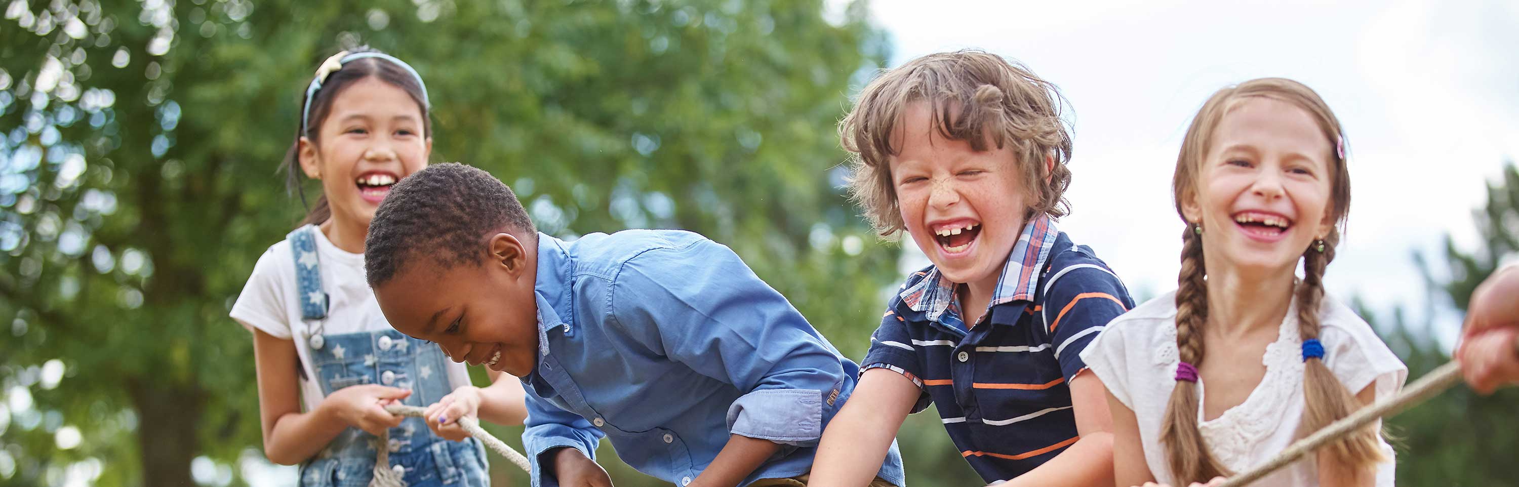 Children playing tug-of-war at the park